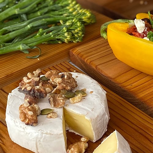 Camembert with walnut topping on a grilling plank Camembert with walnut topping on a grilling plank